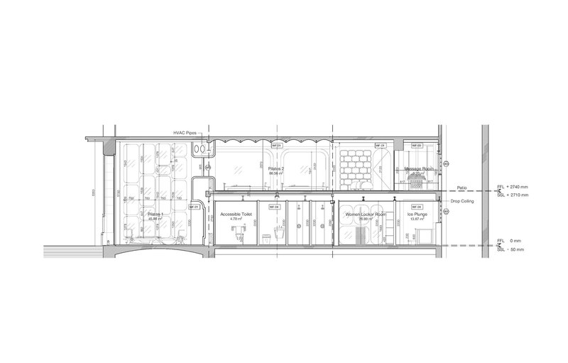 Section drawing showing exercise rooms, toilet facilities, locker spaces, and vertical circulation with level annotations