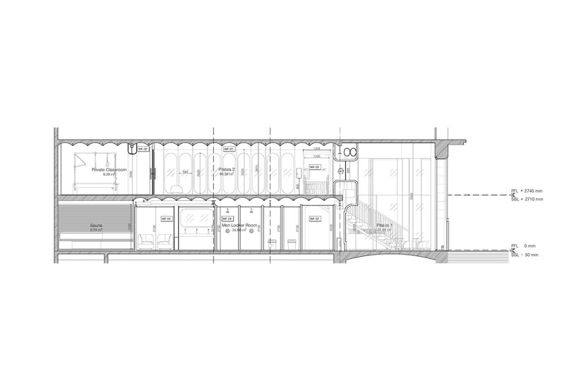 Section drawing revealing private classrooms, exercise areas, service spaces, and a descending staircase