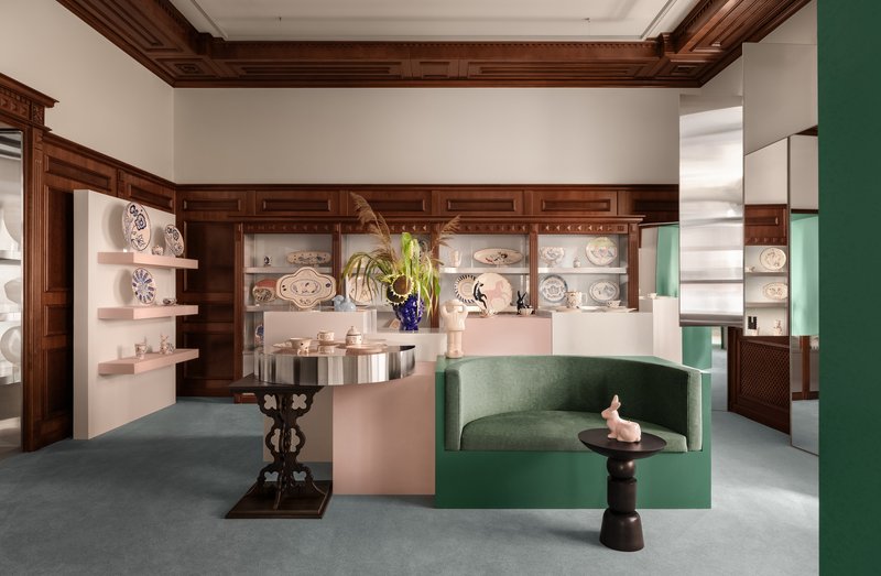 Interior room with dark timber coffered ceiling, built-in shelving and green upholstered seating