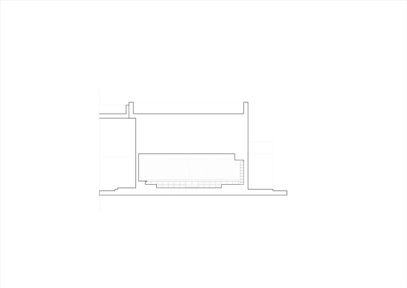 Section drawing revealing interior volume with stepped floor levels beneath flat roof plane