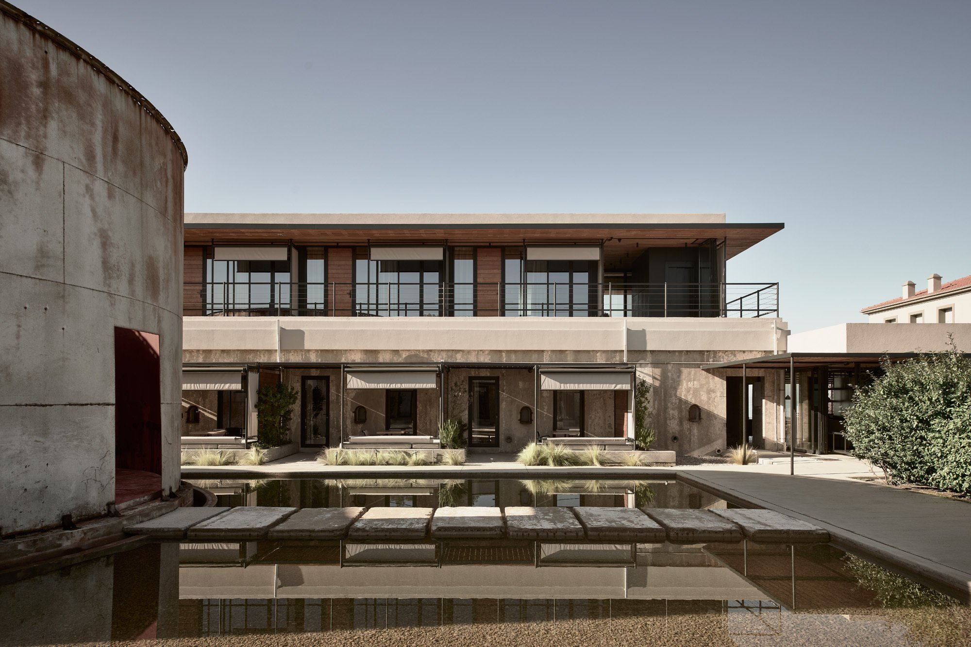 K-Studio Extends a 1920s Greek Wine Factory into a 45-Key Seaside Hotel on the Peloponnese Coast