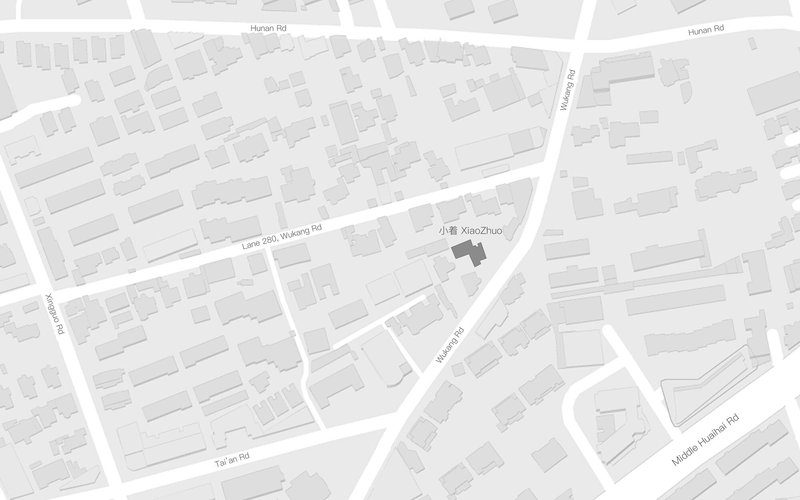Site plan showing building footprint highlighted in dark grey within a network of urban blocks and streets