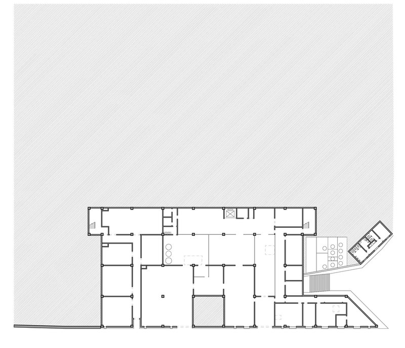 Floor plan drawing showing a rectangular volume with multiple rooms and an angled extension wing