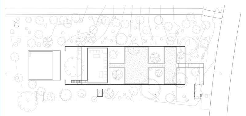 Site plan drawing showing linear volumes surrounded by landscaped grounds with scattered tree symbols