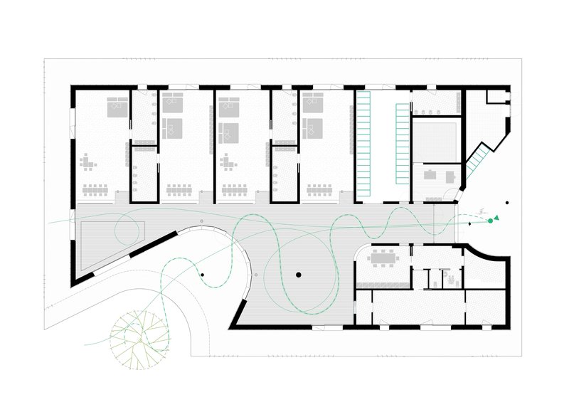 Floor plan drawing showing four classroom spaces along one edge and a central circulation zone with curved pathways
