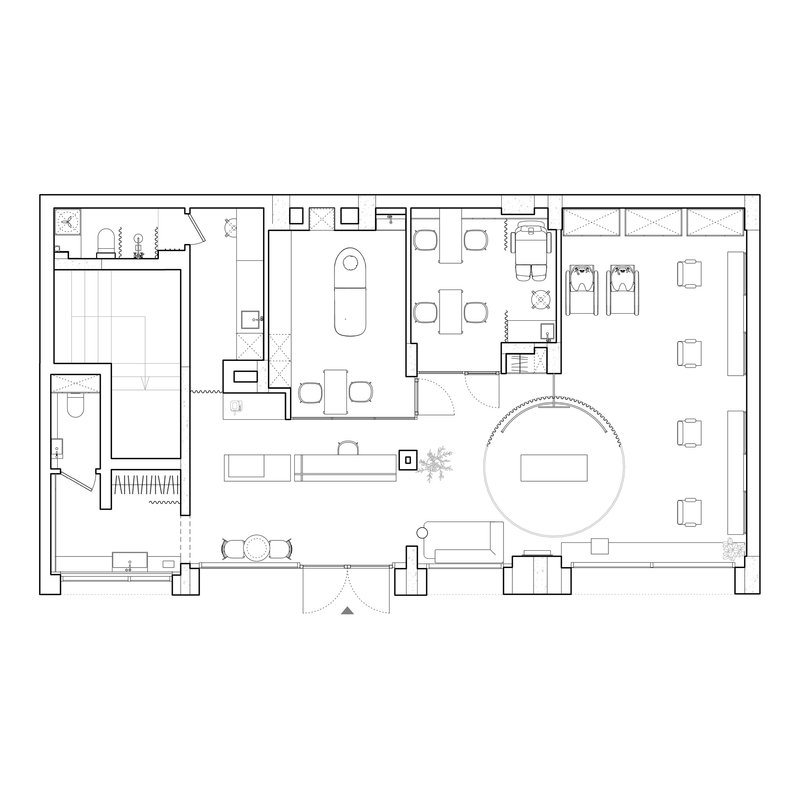 Floor plan drawing showing furnished interior spaces with a circular feature and divided program zones