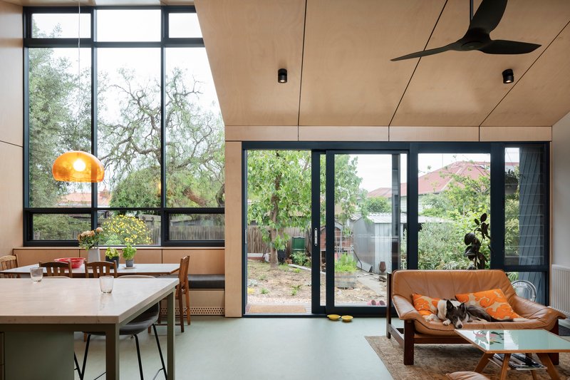 This architectural photo showcases a modern interior with a seamless blend of indoor and outdoor spaces. The design features large windows and sliding doors tha