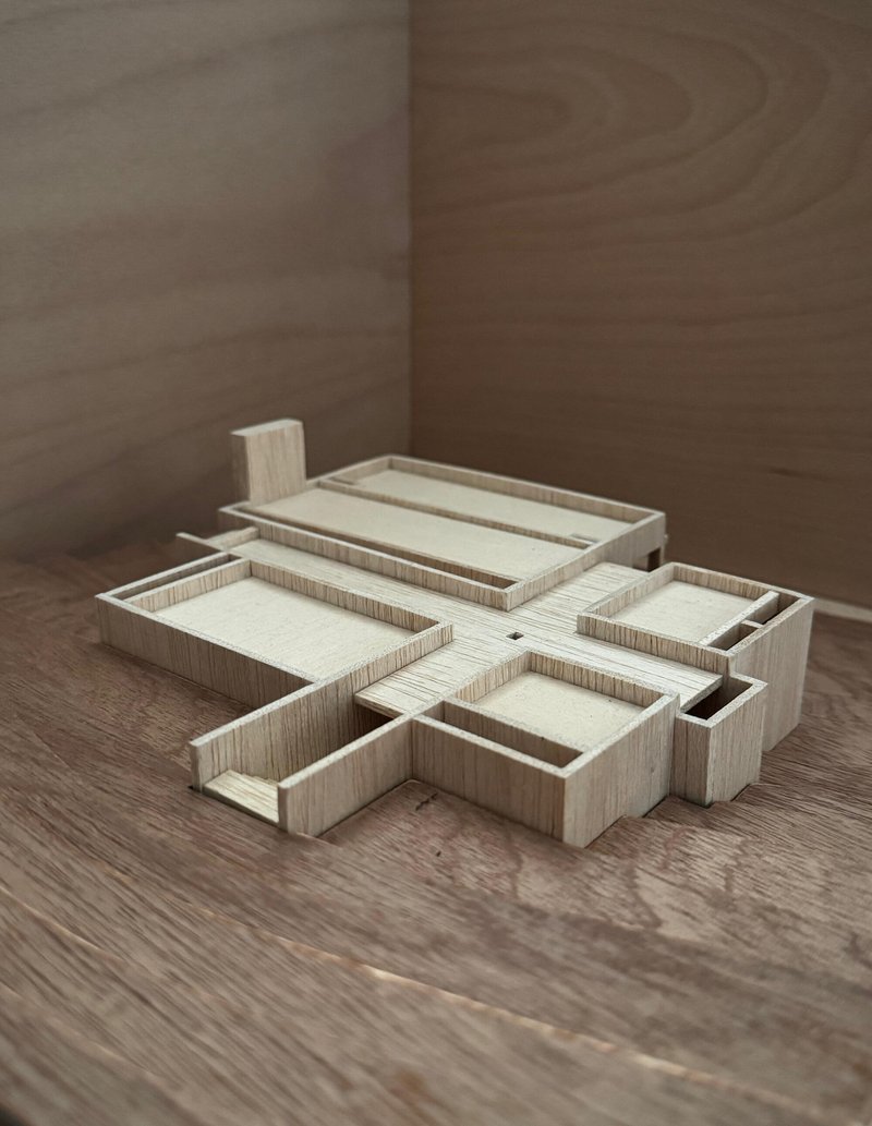 Oblique view of the layered wood study model showing terraced volumes in shadow