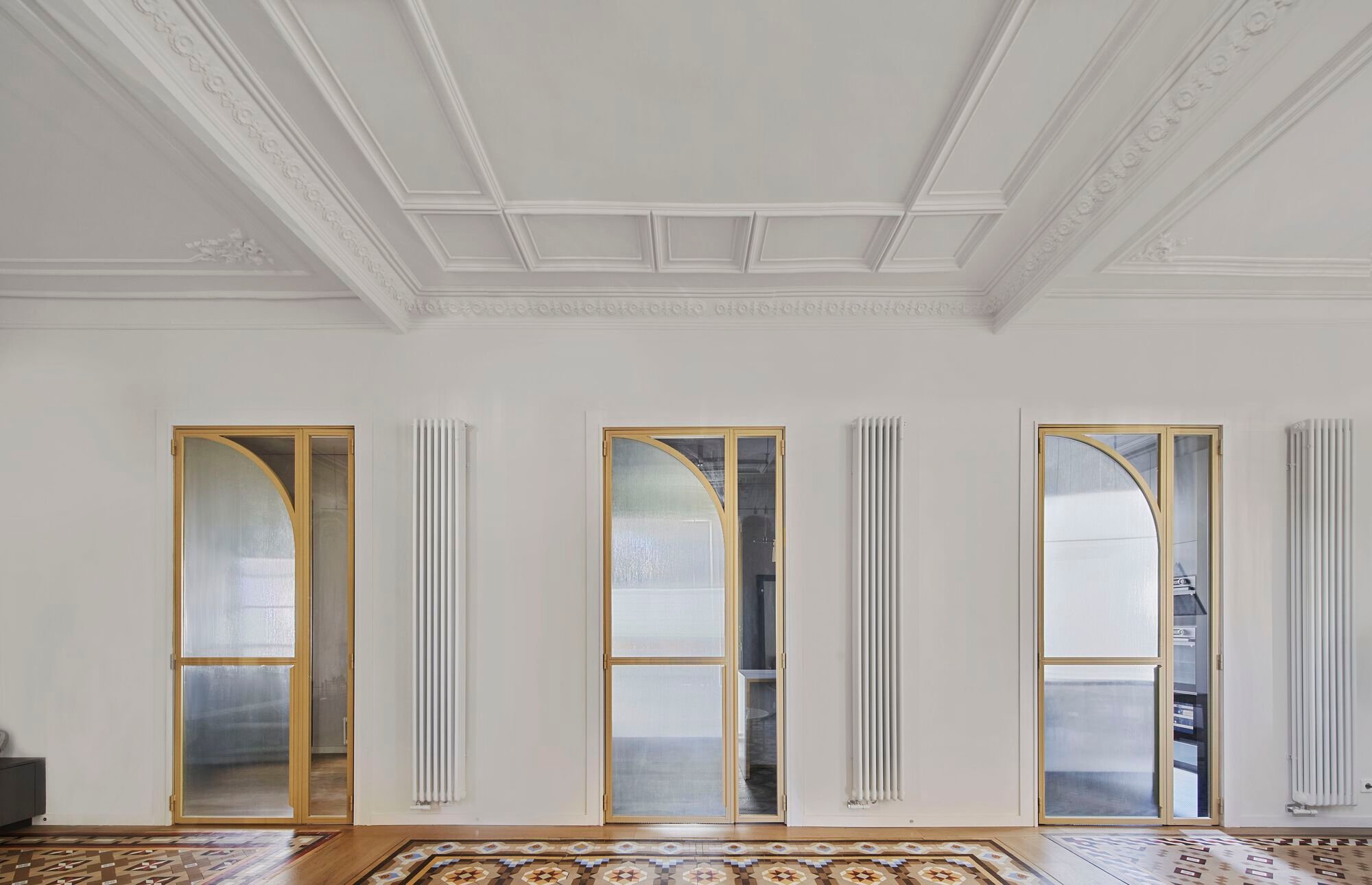Cometa Architects Turns a Dark Barcelona Modernista Apartment into a Cinematic Sequence of Brass and Glass