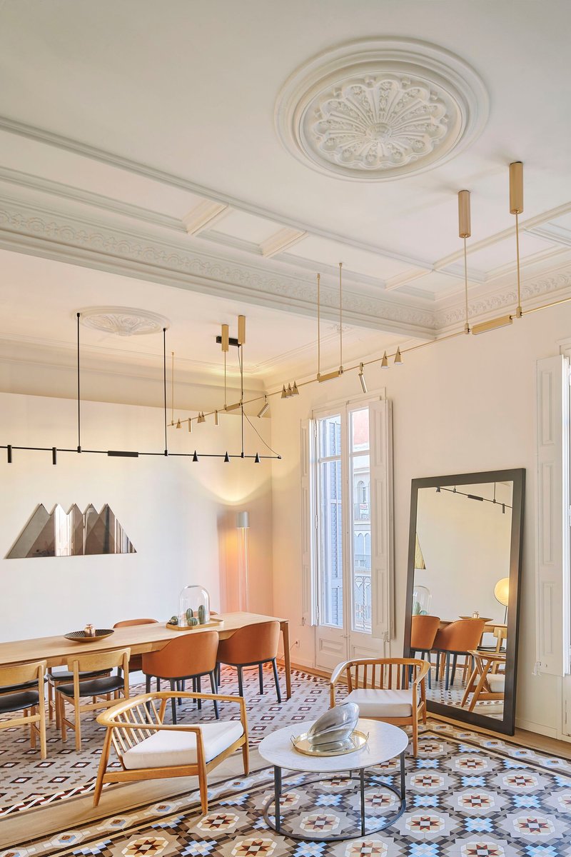 Diagonal view of the living room showing the ornamental ceiling medallion and brass lighting fixtures