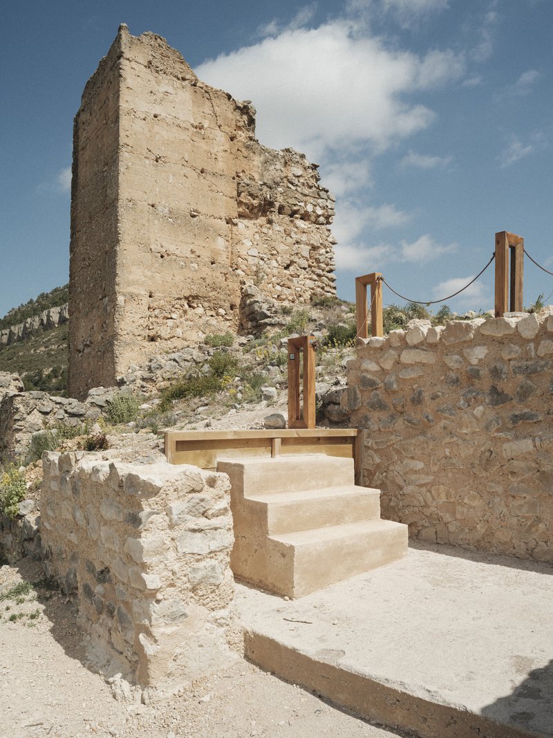 New limestone staircase with timber handrail inserted between reconstructed and ruined stone walls