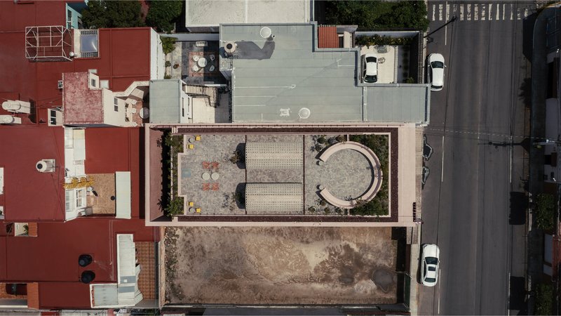 Aerial view showing the narrow lot with circular vault structure and rectangular garden court between neighboring buildings