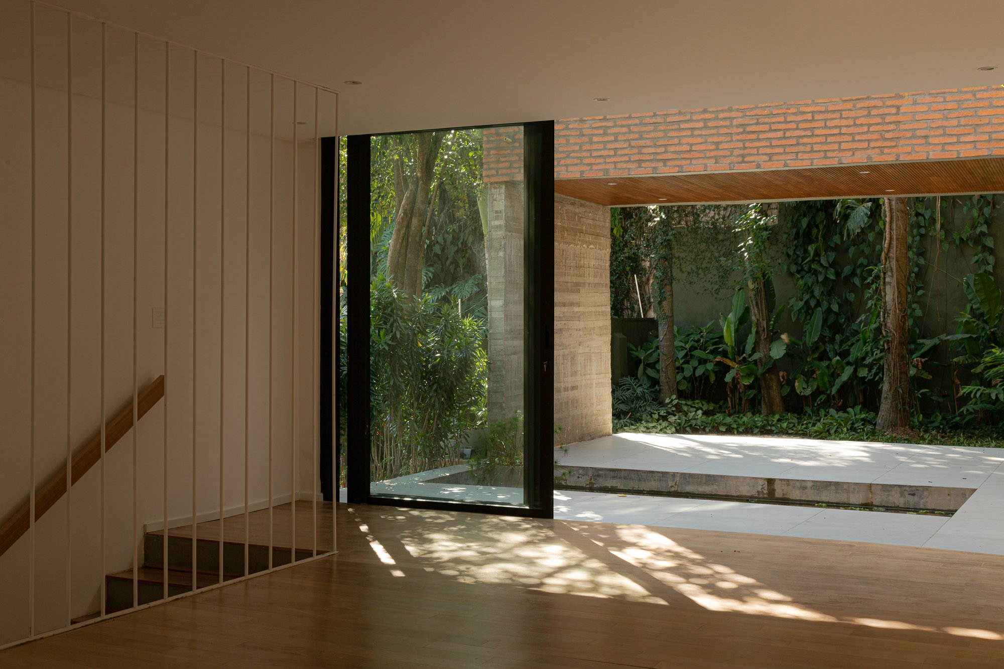 Ateliê Amanhã Carves Precise Voids into a São Paulo Hillside House to Frame Its Fruit Trees