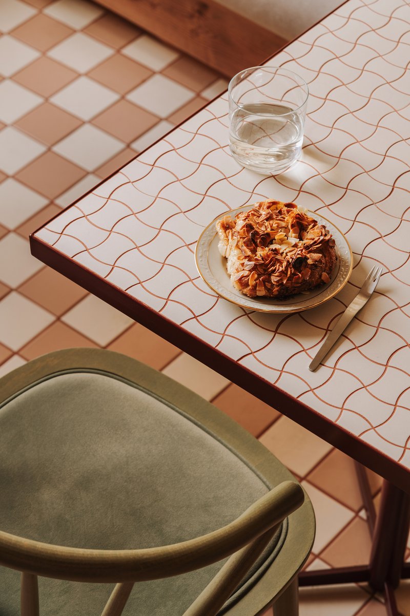 Table with wavy line pattern and rounded tile floor in warm afternoon light
