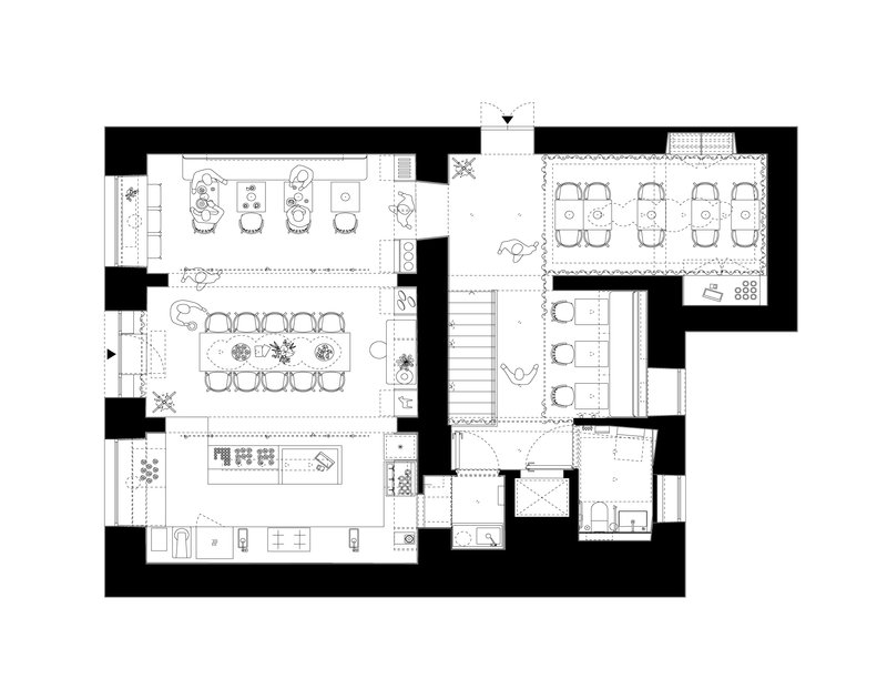 Floor plan drawing showing open dining and meeting spaces with a central staircase and perimeter service rooms