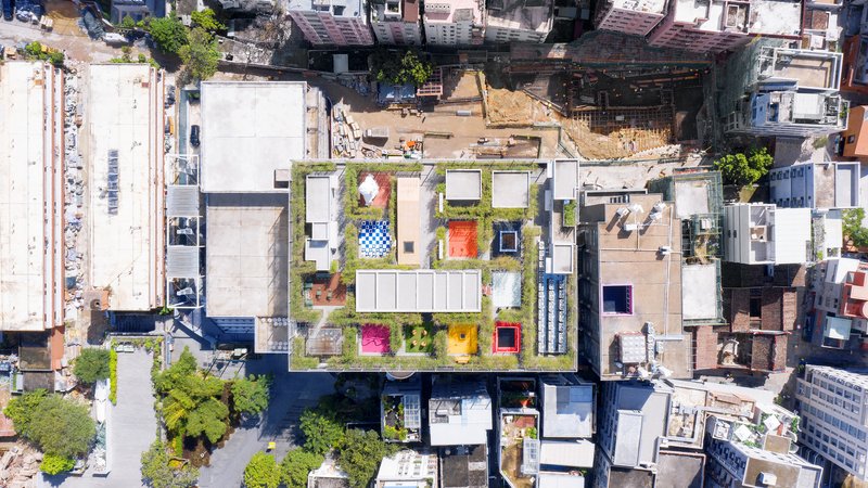 Aerial view of the rooftop garden with colorful tiled pavilions and planted beds between neighboring structures