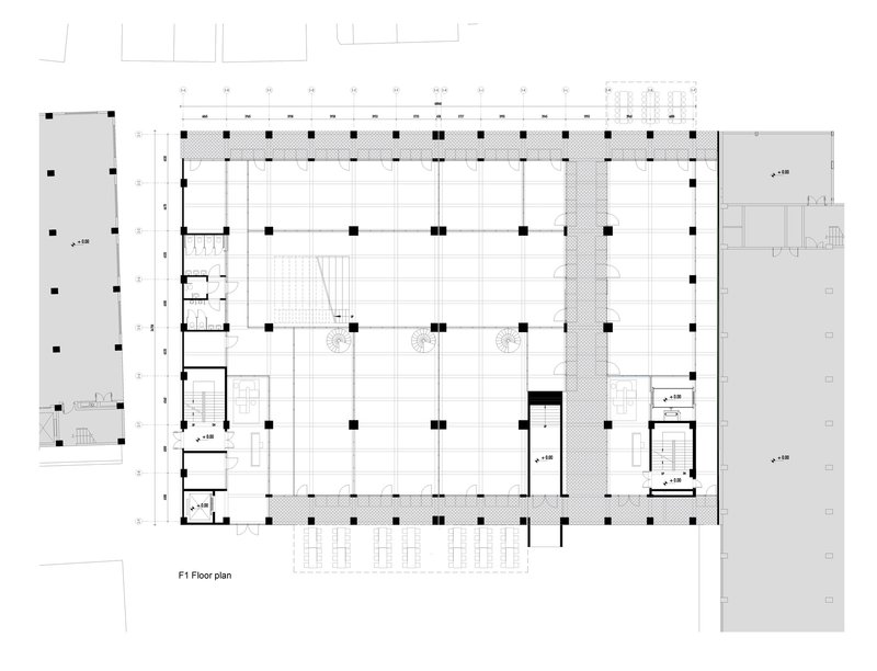 Floor plan drawing showing an open layout with central void and perimeter columns on a grid