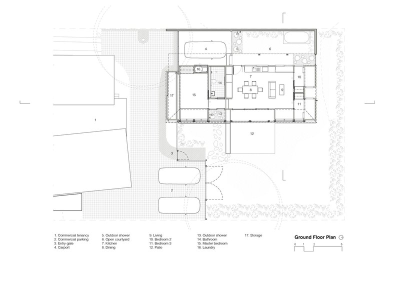 Ground floor plan drawing showing living areas and outdoor courtyard with planting beds and parking spaces