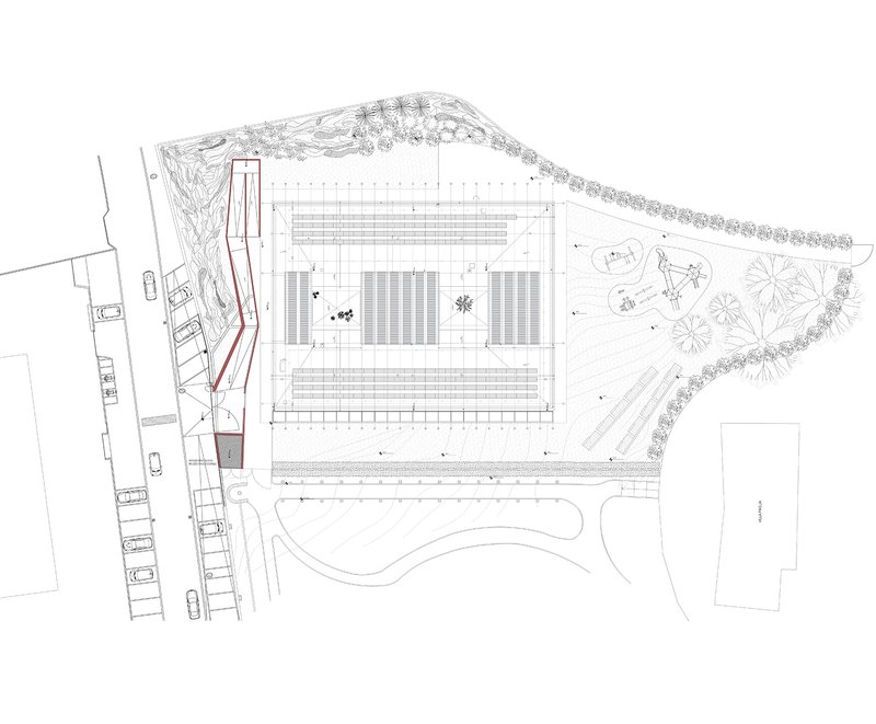 Site plan drawing showing rectangular structure with courtyard spaces and surrounding landscaped areas
