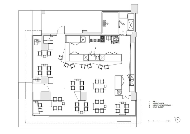 Floor plan showing an open dining area with scattered table groupings and a galley kitchen along one wall