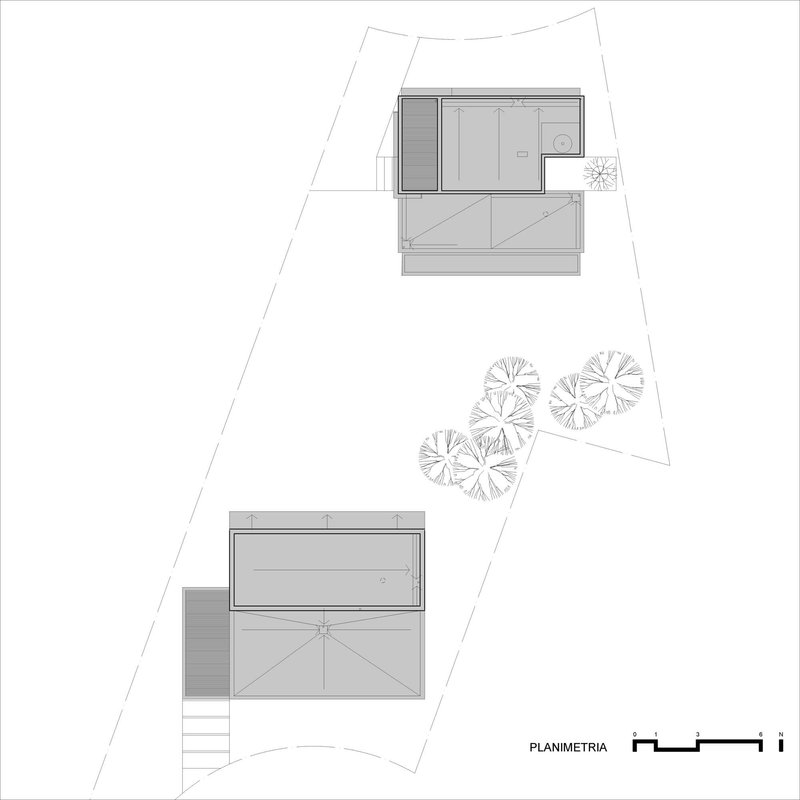 Site plan drawing showing two residential volumes on an irregular lot with tree plantings between