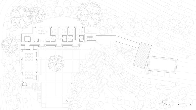Site plan drawing showing the main residence, outbuildings, and surrounding tree canopies on sloping terrain