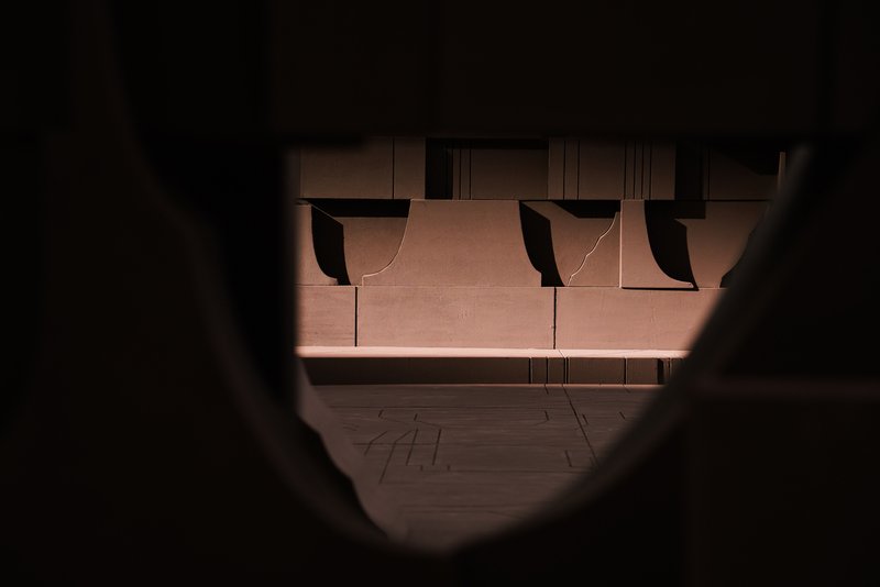 View through a circular opening into a cardboard model with scalloped canopy elements above
