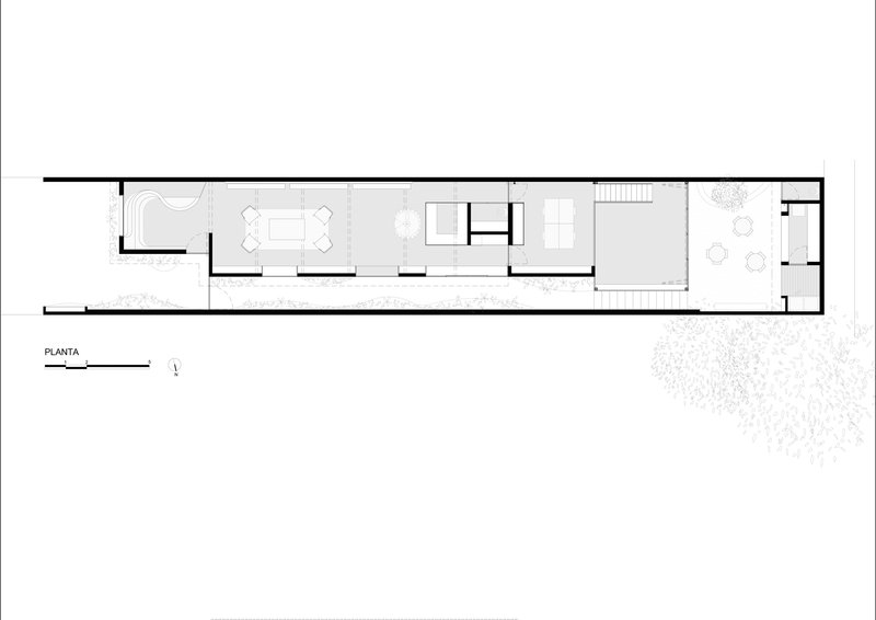 Floor plan drawing showing a narrow linear layout with interior rooms and an exterior courtyard