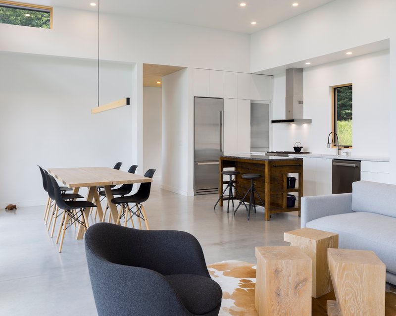Open plan kitchen and dining area with polished concrete floor and clerestory windows