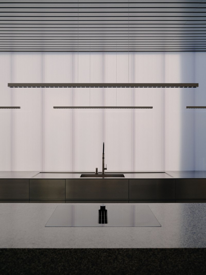 Kitchen island with black countertop against white ribbed wall and linear suspension lights