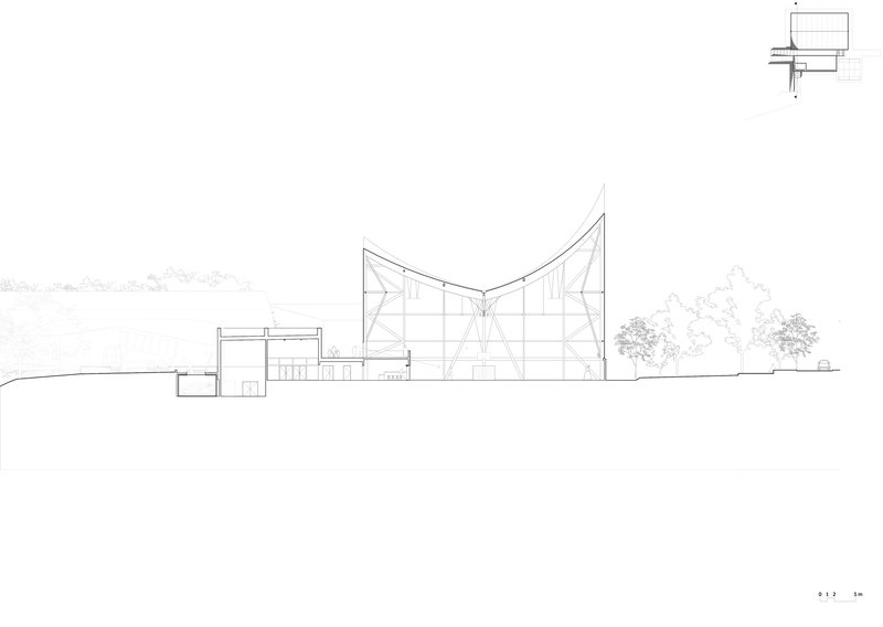 Section drawing showing the curved roof structure with exposed internal framing and adjacent volumes
