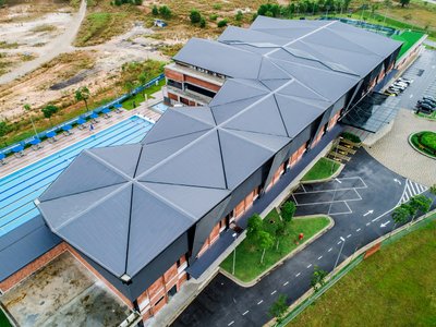 Archicentre Folds an Origami Roof Over a Brick Sports Complex in Iskandar Puteri