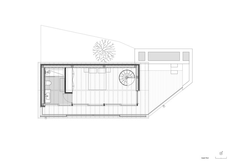 Upper floor plan showing bedroom with bathroom and spiral stair to below