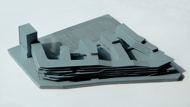 Physical model in grey and black showing layered volumes above a striated base platform