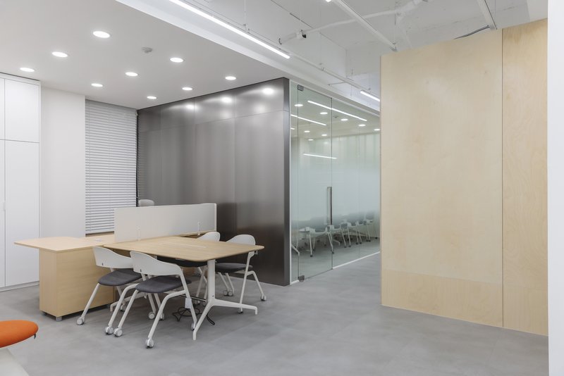Reception desk with polished concrete floor and glass-walled conference room beyond