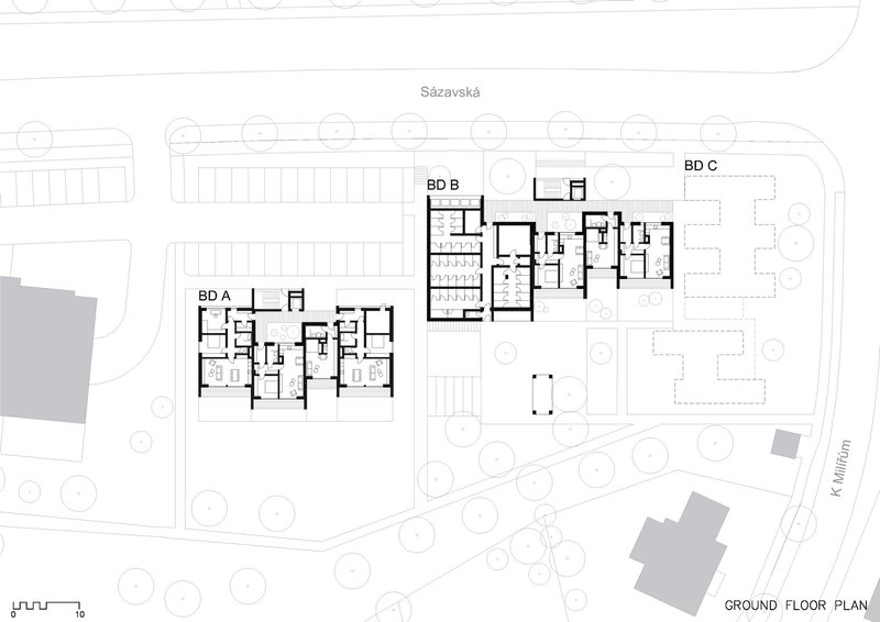 Ground floor plan showing three residential blocks with surrounding landscaped areas and circular trees
