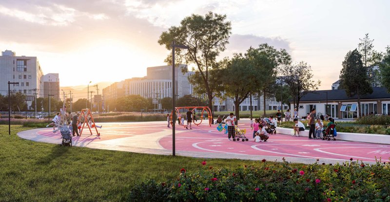 Pink circular play surface with white curved seating edge and children playing at sunset
