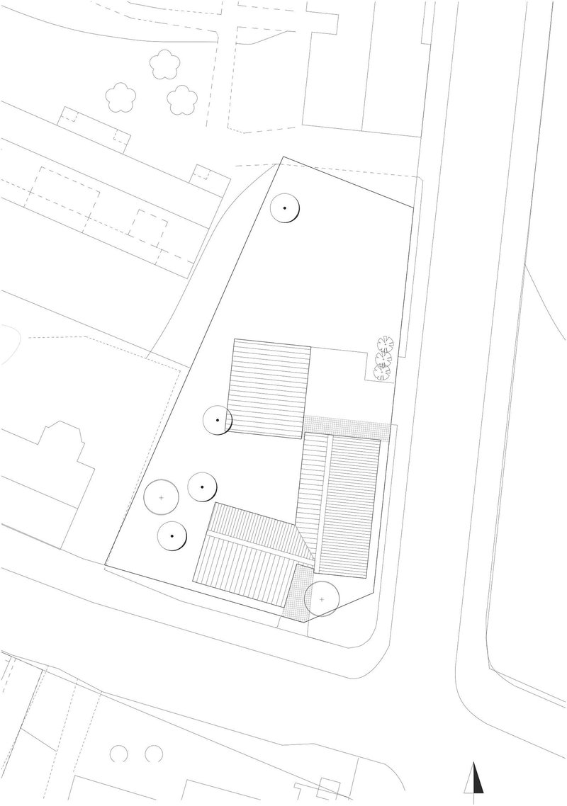 Site plan drawing showing three rectangular roofed volumes arranged around circular tree symbols