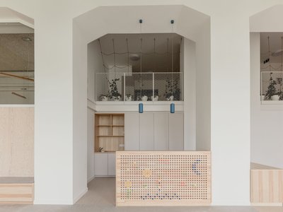 ARCHIKON Architects Turns a 1911 Budapest Apartment Building into a Warm Plywood Playworld