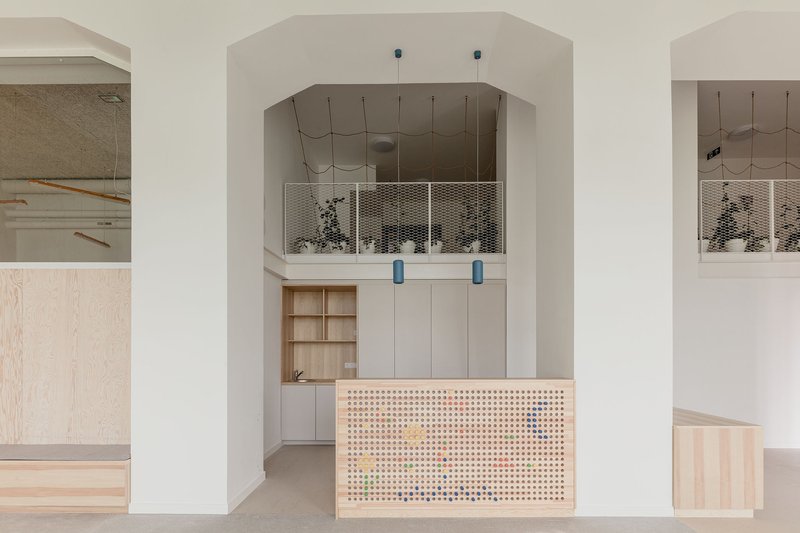 ARCHIKON Architects Turns a 1911 Budapest Apartment Building into a Warm Plywood Playworld