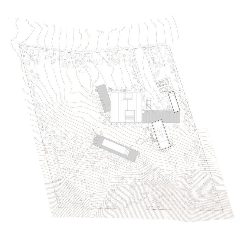 Site plan drawing showing rectangular volumes positioned on sloping terrain with contour lines and vegetation
