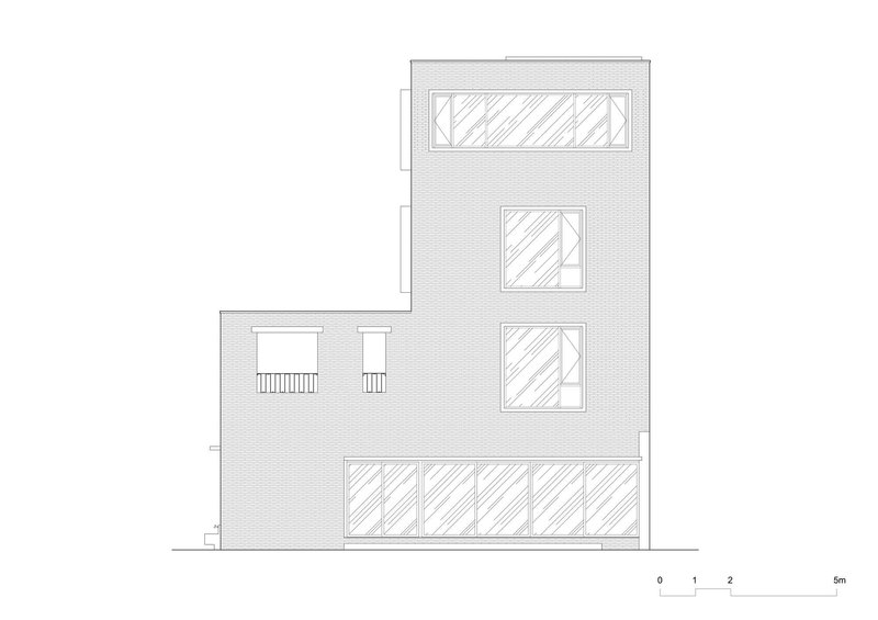 Elevation drawing of brick facade with varied window openings across three stories