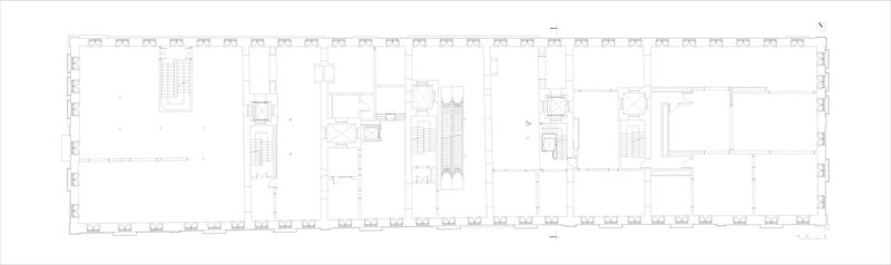 Floor plan drawing depicting an elongated space with staircases and symmetrical side chambers