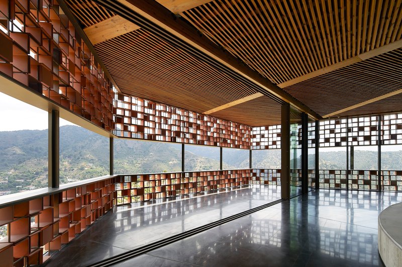 Interior space with timber batten ceiling, mosaic screens and polished floor reflecting mountain views