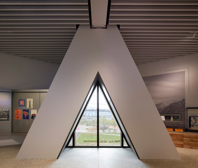Triangular window alcove framing a view of the landscape with gallery displays on adjacent walls
