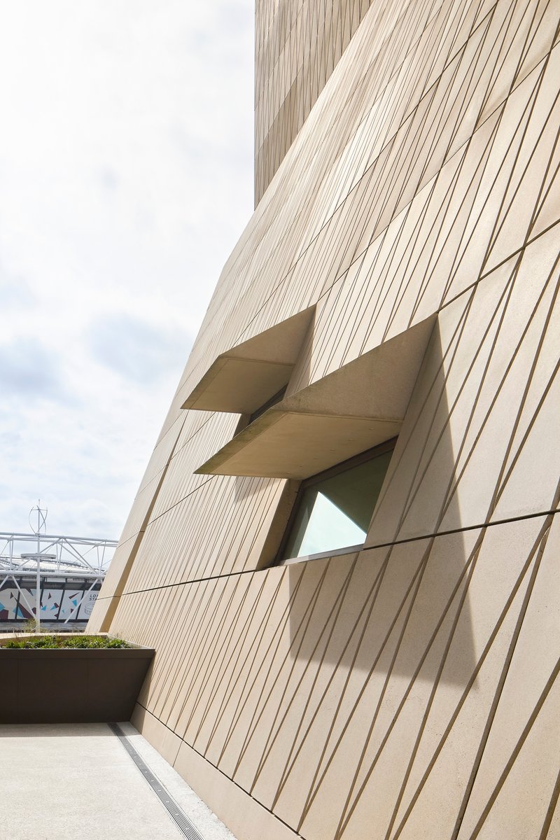 Detail of the angular window recess cutting through the vertically ribbed facade panels