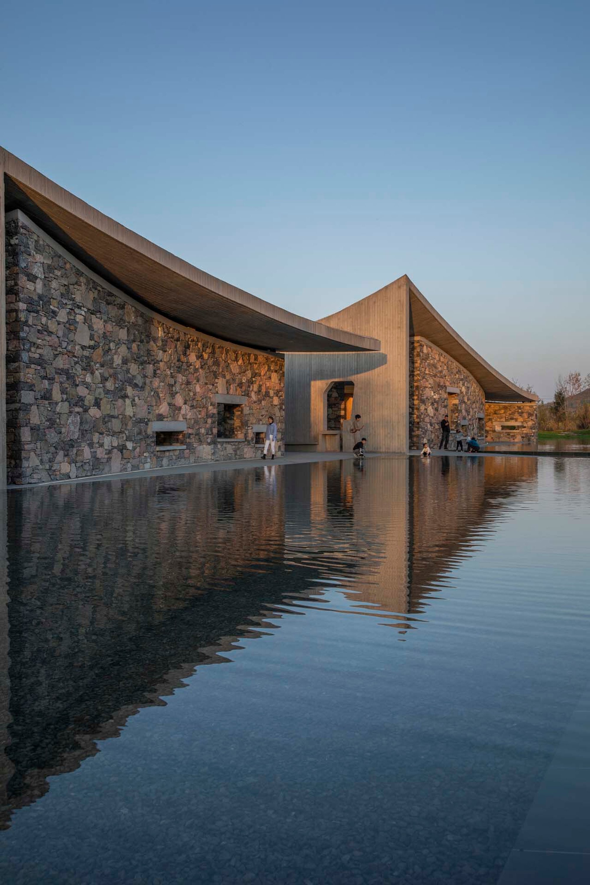 Studio Zhu-Pei Drapes Concrete Tent Roofs Over a Stone Courtyard Art Center in Zibo