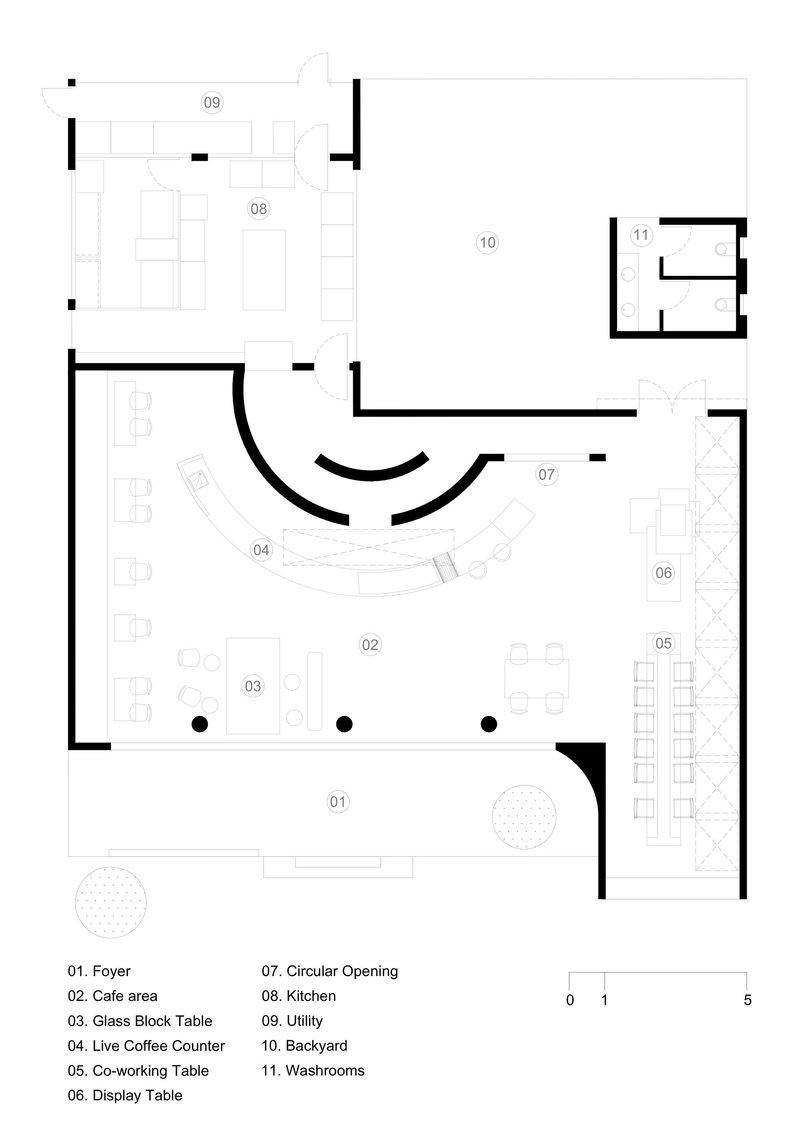 Floor plan showing cafe area with curved counter, co-working tables, and kitchen spaces