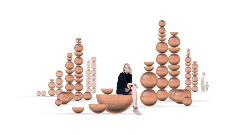 Arrangement of stacked timber spheres and hemispheres with a seated figure in white background