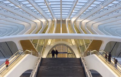 This architectural photograph showcases a modern train station with a futuristic design. The structu